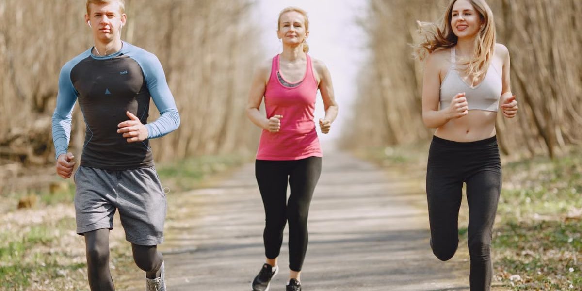 Three adults jogging on a park path, embracing a healthy and active lifestyle.