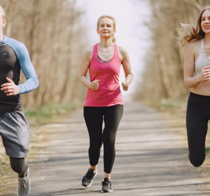 Three adults jogging on a park path, embracing a healthy and active lifestyle.